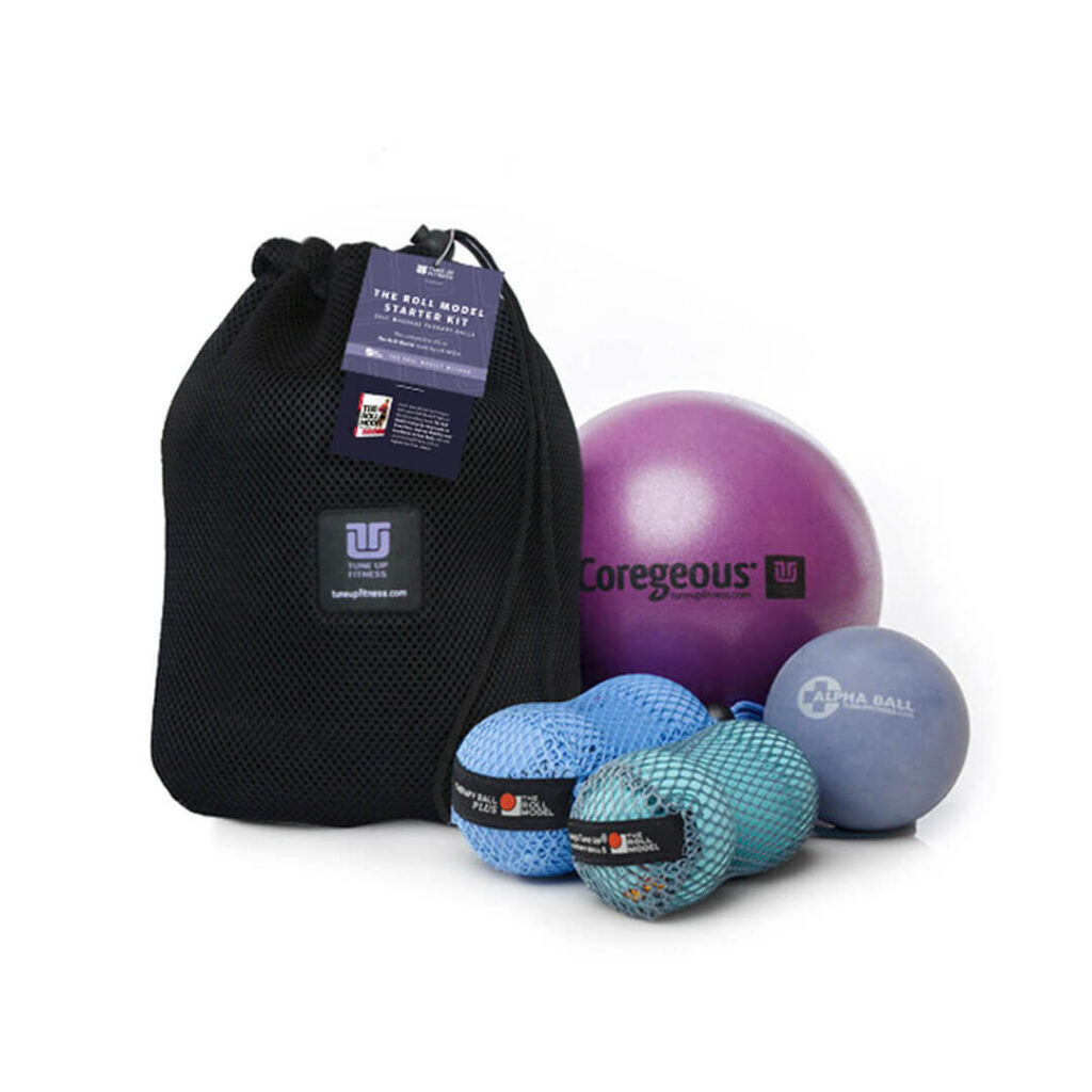 Fitness starter kit with a black mesh bag and assorted exercise balls (purple, blue, teal) for core strength and mobility.